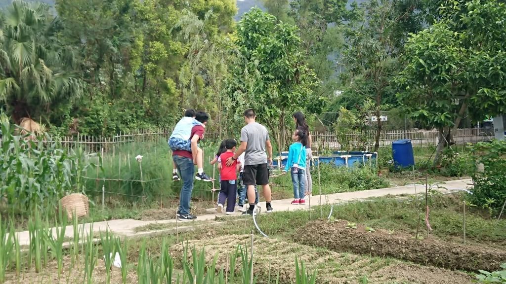 Photo of Chu Kairos at the farm with SEN students